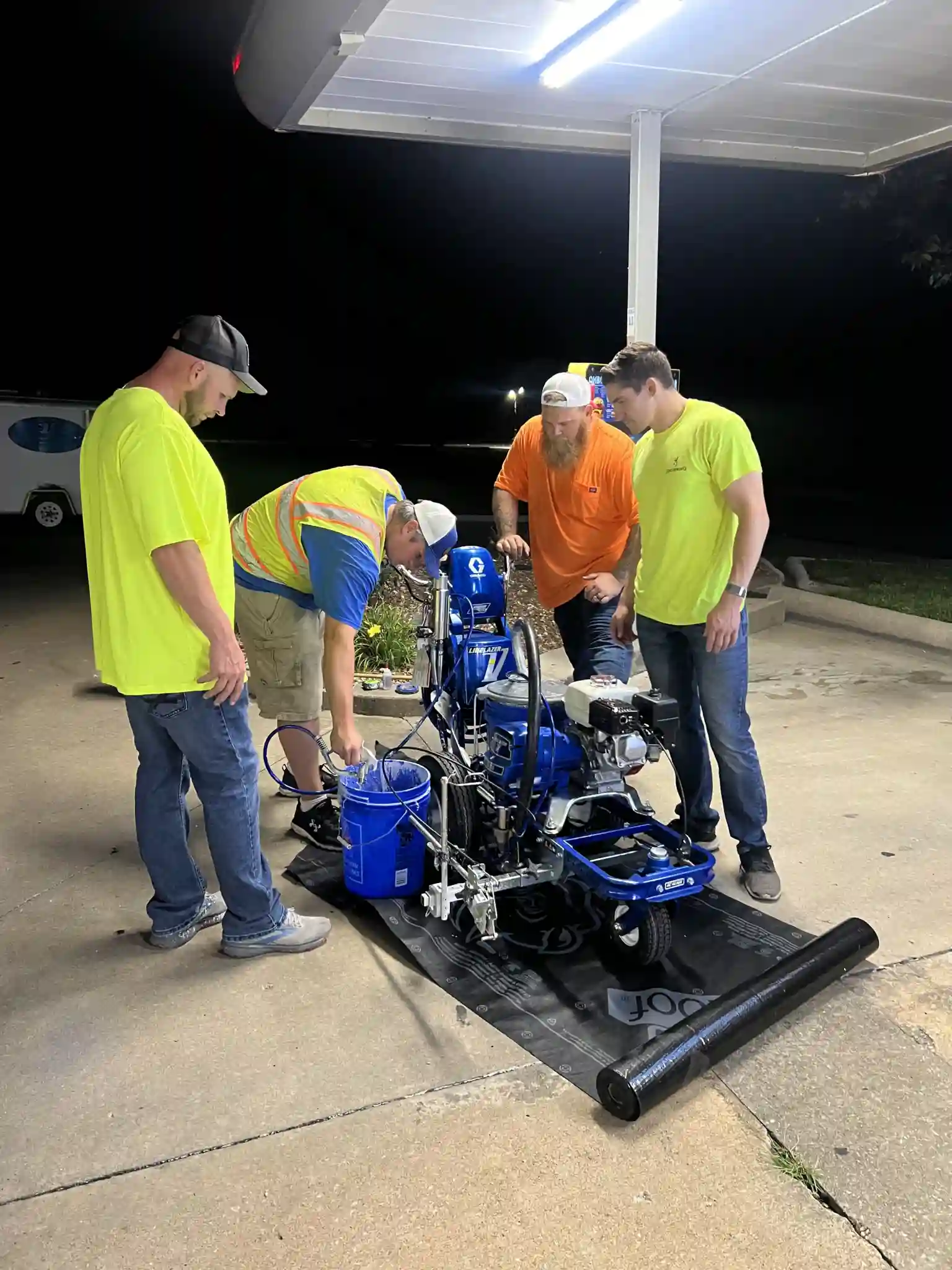 The LineLava team preparing a line striping machine.