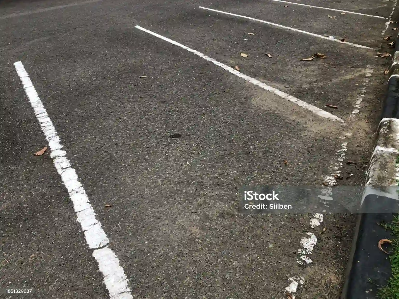 A dirty, empty parking lot.